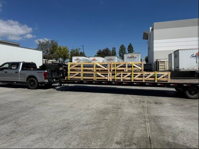 Truck hauling crated freight on flatbed