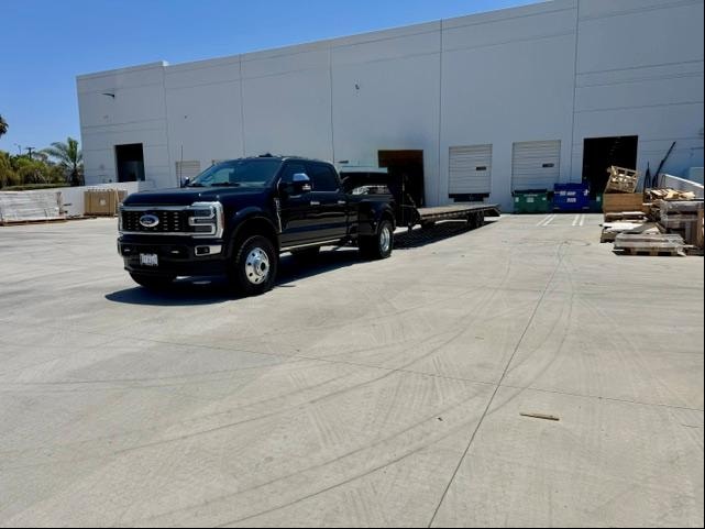 Get Er Dun LLC truck and flatbed trailer at commercial facility